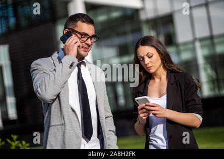Business colleagues are communicating outside the company building. Stock Photo