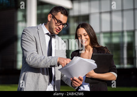 Business colleagues are talking outside the company building. Stock Photo