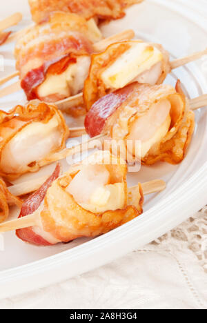 Shrimp appetizer made with pepper jack cheese wrapped in bacon. Wooden skewers makes for an easy serving as an appetizer or snack. Shallow definition Stock Photo