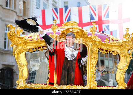 William Russell, the 692nd Lord Mayor of the City of London, waves from the State Coach during the Lord Mayor's Show in the City of London. Stock Photo