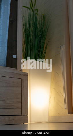 Cozy lanterns in a vase, decorating a room. Stock Photo