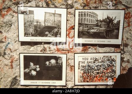 Michael Scott/Alamy Live News - Berlin, Germany April 1990 - Pictures for sale at a stall showing the fall of the Wall. The images are hanging from a section of the wall taken in West Germany in April 1990, months after the Berlin Wall fell in 1989. Stock Photo