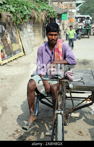 Rickshaw driver waits for the next customer in Baruipur, West Bengal, India Stock Photo