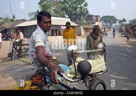 Rickshaw driver waits for the next customer in Baruipur, West Bengal, India Stock Photo