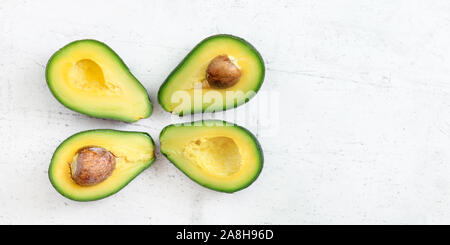 Overhead shot of four green avocados in a rectangular shaped straw fruit  basket Stock Photo - Alamy