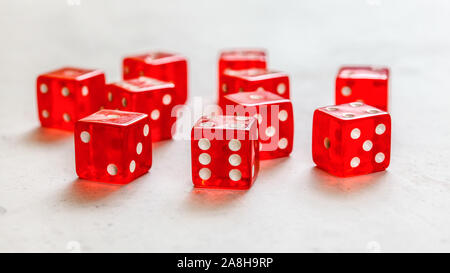 Red craps dices on white board showing different numbers. Stock Photo
