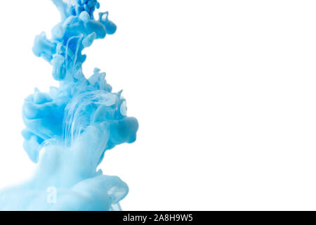 Abstract flowing liquid or blue ink in water on a white background. It looks like smoke or cloud. Or zero gravity. Stock Photo