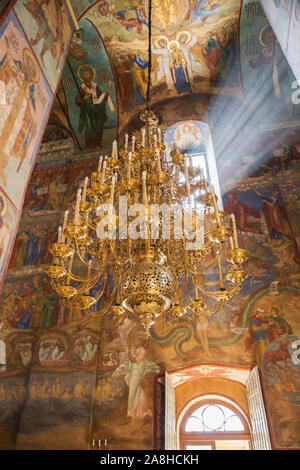 SERGIEV POSAD, MOSCOW REGION, RUSSIA - MAY 10, 2018: Trinity Lavra of St. Sergius, interior of Assumption Cathedral. Large gilded candelabrum against Stock Photo