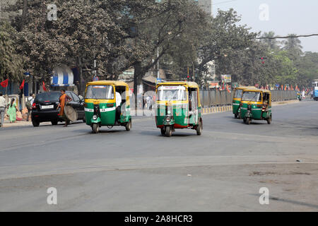 Auto rickshaw three weeler tuk-tuk taxi drives down the street in Kolkata Stock Photo