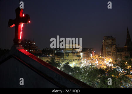 Dark city traffic blurred in motion at late evening on crowded streets, view from the Catholic Cathedral in Kolkata Stock Photo