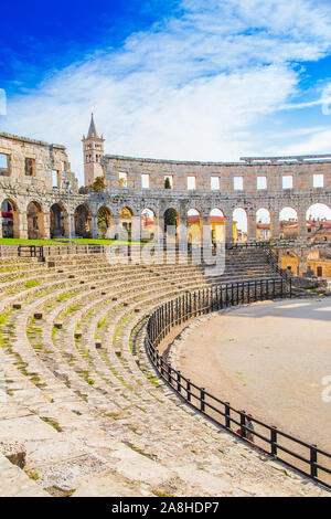 Monumental ancient Roman arena in Pula, Istria, Croatia, interior of historic amphitheater, wide angle view of high walls on blue sky background Stock Photo