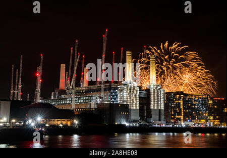 Battersea Fireworks light the sky behind and illuminated Battersea Power Station Stock Photo