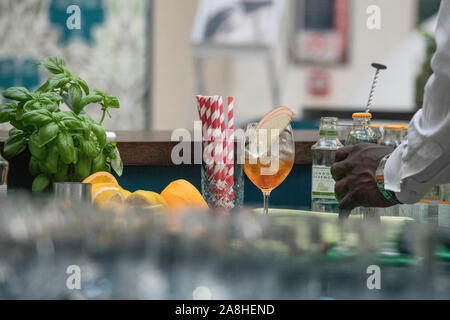 A Pimms is prepared in a bar with paper straws Stock Photo