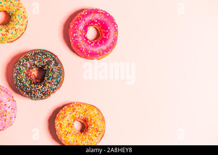 Group of glazed donuts on background pink with copy space. Food, restaurant, bakery concept Stock Photo
