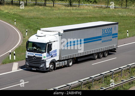 ICOM Mercedes-Benz Actros truck with curtainside trailer on motorway. Stock Photo