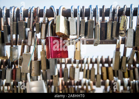 A close-up shot of love locks on a fence Stock Photo
