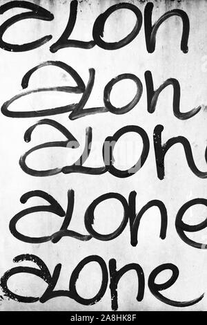 Word 'alone' written on grungy wall. It can be used as a poster, wallpaper, design t-shirts and more. Stock Photo