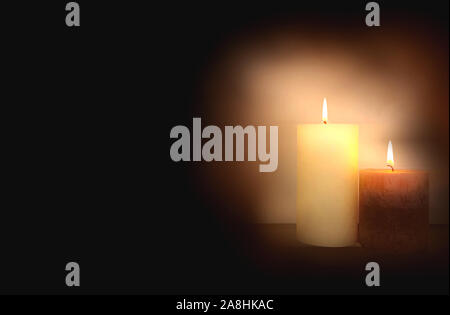 Two burning brightly candles in the dark shadow, space for text romantic colorful concept background Stock Photo