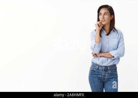 Thoughtful intrigued good-looking caucasian adult lady entrepreneur have interesting thought, look left interested pondering, touch chin, searching Stock Photo