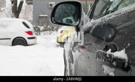 Cars driving through snow-covered road. Stock Photo