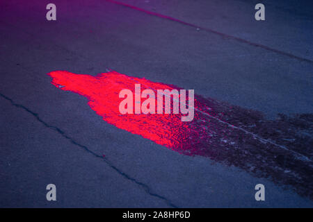 ice on asphalt at night. icing spikes transport safety. detail Stock Photo