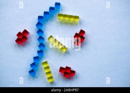 Building blocks illustrating concepts of design, construction, science, medicine, society, economy, play. Colorful - yellow, red, blue. Stock Photo