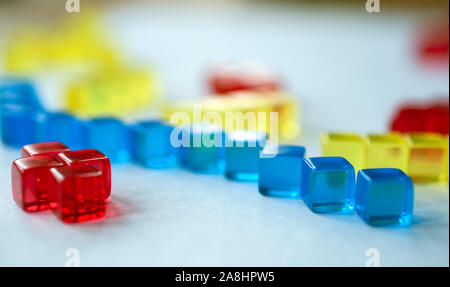 Building blocks illustrating concepts of design, construction, science, medicine, society, economy, play. Colorful - yellow, red, blue. Stock Photo