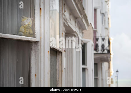 sad broken wee bear at window Stock Photo