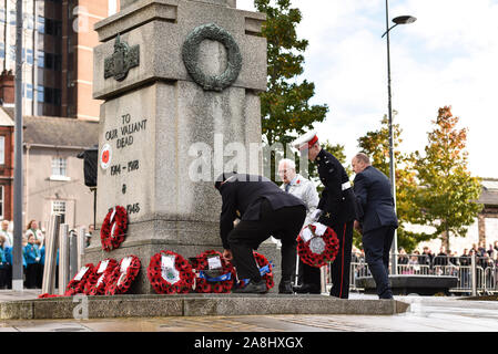 Veterans and civilians lay reefs and notes of condolence to the fallen at the Remembrance Day, armistice day parade in the city centre of Hanley, Stock Photo