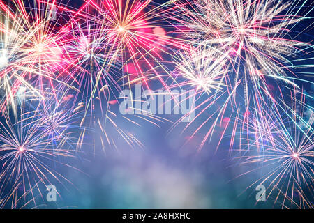Festive celebration firework lights in the dark night sky Stock Photo