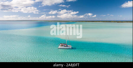 Sailing with catamaran in Tuamotu Archipelago french Polynesia - Aerial view of the lagoon by drone