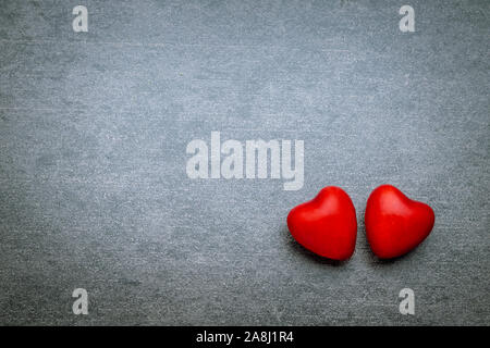 Two lovers hearts on gray background. Valentines day concept. Stock Photo