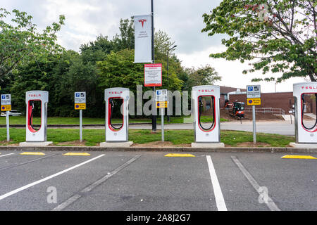 Tesla charging stations at the motorway services in the UK, Electric charging, electric vehicle charge points, service stations eco cars Stock Photo