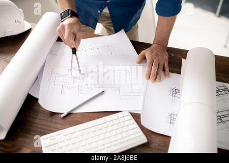 Contemporary architect with dividers making sketch of building construction Stock Photo