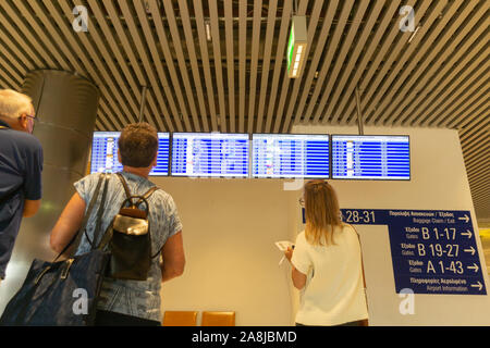 Athens Grece - August 6 2019; Travelers checking arrivals and departures boards in airport Stock Photo