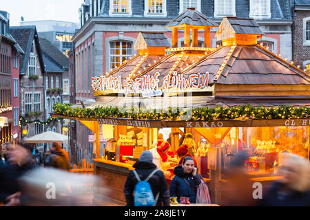 AACHEN - DECEMBER 14: Hexenhof Christmas market stall for food and beverages in Aachen with people passing on December 14, 2017 Stock Photo