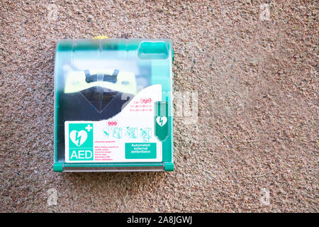 Defibrillator AED on wall for public use in a town England Stock Photo