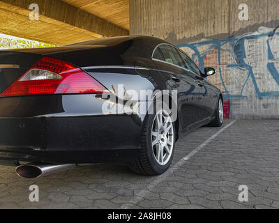 The back of the dark car is a close-up. red lights Stock Photo