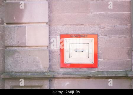 Nightsafe metal box in wall with red trim to keep one safe at night Stock Photo