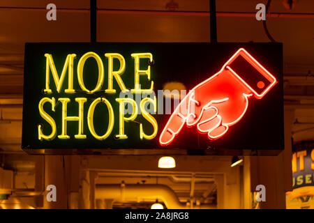 More Shops Neon Sign in indoor market area Stock Photo