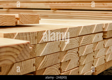 End view of stacked floorboards. Wooden structure closeup. Stock Photo