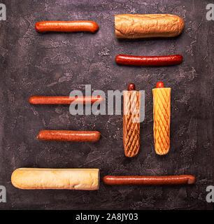 Ingrdients for hot dogs buns various sausages on black concrete background. copy space, top view Stock Photo