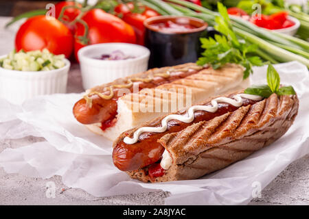 Hot dogs, tomatoes on white background. Fast food, american tradditional meal Stock Photo