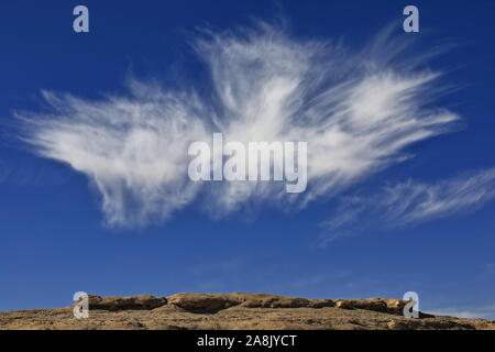 Cirrus uncinus-mares.tails cloud over yardang-wind eroded rock surface. Qaidam desert-Qinghai-China-0571 Stock Photo