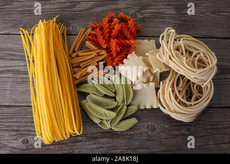 Different types of pasta on wooden background. Top view Stock Photo