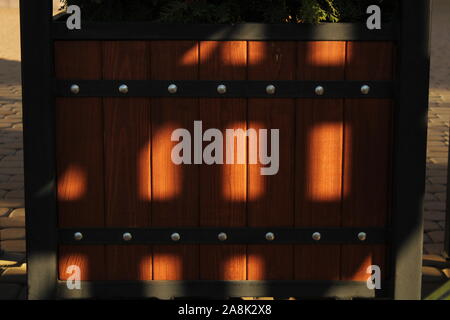This is a wooden brown box with a metal frame in my yard, which is lit by the evening sun. Stock Photo
