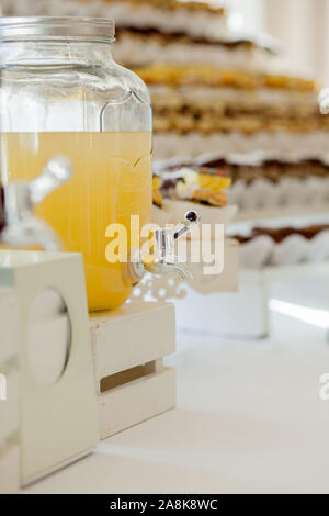 Glass jars of lemonade on wedding candy bar. Catering. Drinks on wedding party. Stock Photo