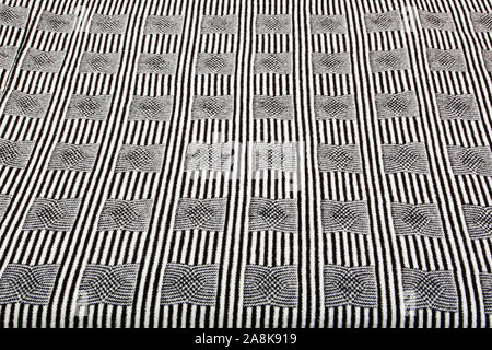 Real heather grey knitted fabric made of synthetic fibres textured background. Stock Photo