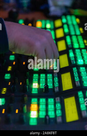 Video Operator makes adjustments on a professional broadcast television camera, shallow depth of field. Stock Photo
