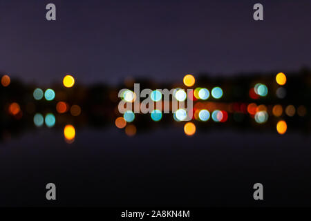 Multicolored bokeh of the night city. The lights are out of focus. Color blurred background Stock Photo